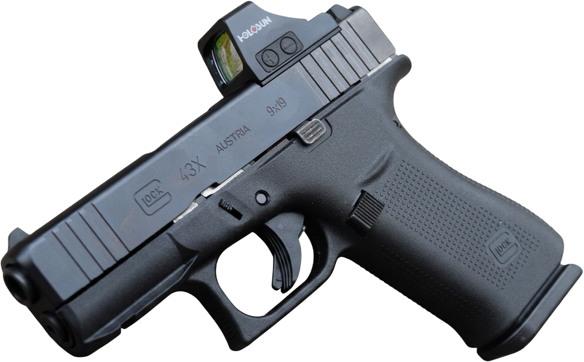 Glock 43X slimline 9mm pistol fitted with a Holosun red dot optic, resting against stone