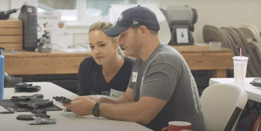 Couple learns firearm safety together at a training session—don’t be afraid to ask for help.